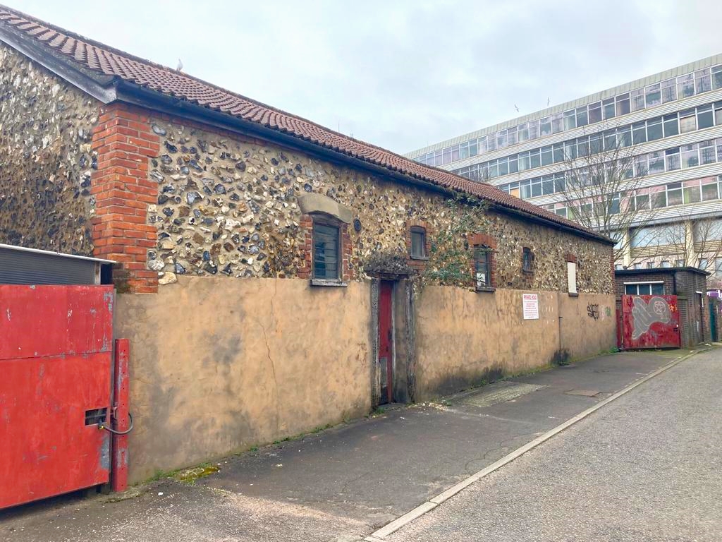 The barn and retaining wall believed to be the Medieval remains of St Olave's Church [Credit: Mark W