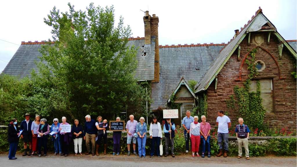 Residents of Garway gather outside the Old School in protest of its demolition.